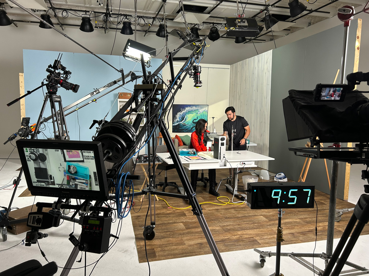 Kestrel and Evan setting up equipment stands for her Quilting in Augmented Reality segment